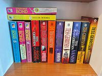 Shelf view of all 13 paperback books showing spines and titles