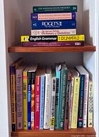 Two shelves showing majority of writing, grammar and reference books