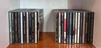 Two rows of CD jewel cases showing 25 spines