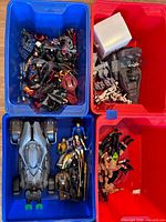 Overview of four tubs containing assorted figures and vehicles