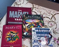 Top view of four hardcover Marvel books showing titles and covers