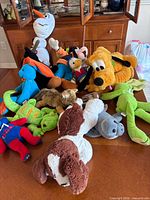 Group of all assorted plush toys on table