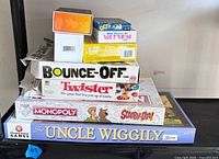 Stacked view of all seven boxed games showing titles and box edges