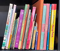 Shelf view of children’s books showing assorted spines and titles
