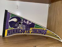 Triangular felt pennant with Vikings helmet graphics