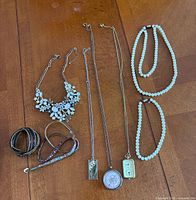 Clear view of nine main jewelry pieces laid on table