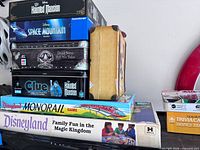 Stacked view of eight Disney games showing titles on box ends