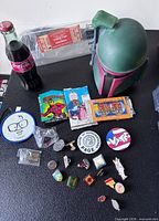 Overview of all items including helmet, bottle, patches, pins, card packs and ticket