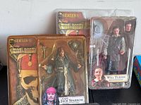 Front view of both sealed action figures in packaging