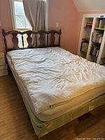 Full view of bed with mattress, topper, box spring and frame