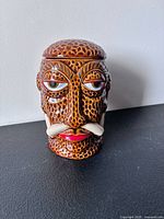 Front view of ceramic tiki mug with lid