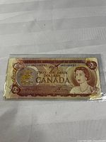 Full view of 1974 Canadian $2 note front side in sleeve