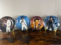 Front view of all four Elvis Presley collector plates on stands