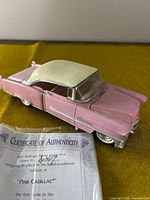 Pink Cadillac music box with roof attached, certificate visible