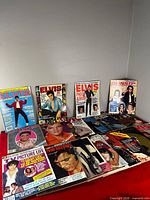 All magazines displayed on table, showing variety of covers and quantities