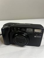 Front view of Ricoh RZ-700 camera showing lens, flash, branding