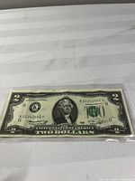 Full view of $2 bill front in sleeve