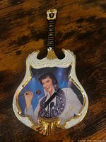 Front view of guitar-shaped Elvis Presley plate with gold trim and portrait