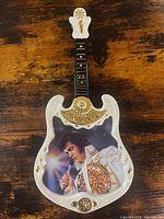 Front view of guitar-shaped Elvis Presley collector plate showing portrait, signature, gold trim