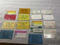All 16 tickets and flyers arranged in four-by-four grid