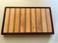 Top view of striped footed wooden cutting board