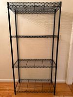 Full front view of black 4-tier wire shelving unit