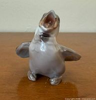 Front view of porcelain fledgling sparrow figurine