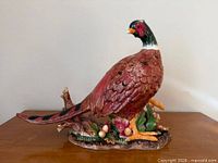 Full side view of ceramic pheasant on harvest base