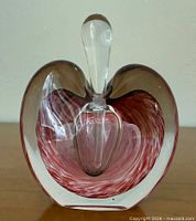 Front view showing red swirl core, clear outer casing, stopper inserted