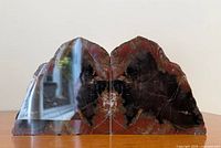 Front view of both petrified wood bookends showing polished faces and coloration