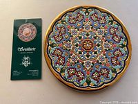 Front view of platter beside brochure