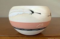 Side view showing feather motif and peach band