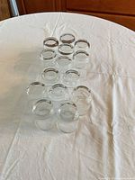All 12 clear straight-sided glass tumblers grouped together