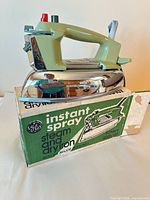 Iron on top of original box showing color and branding