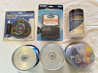Full lot overview showing CD spindle, CD cleaning kit, cleaning wipes, Rolodex organizer