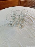 Six clear wine glasses grouped on table