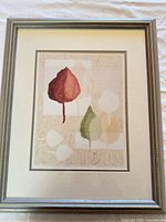 Front view of framed botanical leaf print showing design, mat and frame