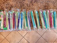 All toothbrushes lined on countertop showing quantity and packaging