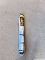 Full view of packaged rolled sunshade