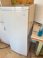 Front view of Kenmore upright freezer with manual on top