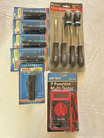 Group shot showing five Gordon flashlights, Pittsburgh screwdriver set, Cen-Tech multimeter