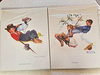 Both prints side by side in plastic sleeves