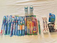 Full lot overview showing toothbrushes, floss, interdental sets, lip balm and baby powder
