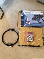 Lot overview showing box, ring, wrapped mat, DVD