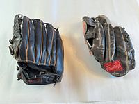 Both gloves front view, showing Rawlings patch and general wear