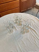 All twelve clear stemmed wine glasses grouped on table
