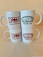 Four mugs showing both FOS and Council logo sides