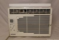 Front view of window air conditioner showing grille, louvers and control panel