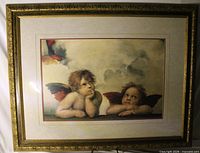 Front view of framed cherub print in ornate frame