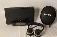 Sony docking speaker, Tuiny headphones and case grouped together